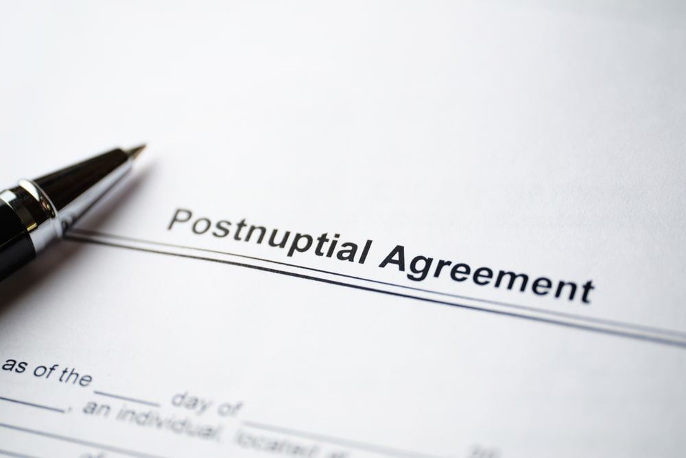 Postnuptial Agreement On Paper With Pen - Jones Divorce & Family