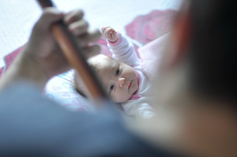 man playing guitar to baby