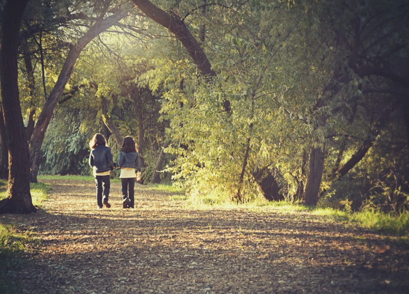 Two Girls Walking In Woods